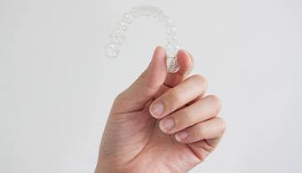 Patient holding clear aligner