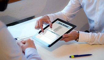 Patient reviewing dental insurance forms on tablet
