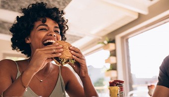 Woman about to bite into a delicious sandwich