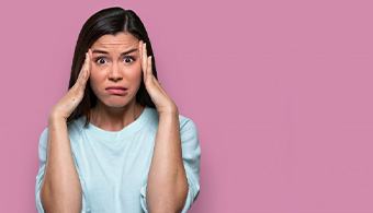 Woman holding her head and looking stressed