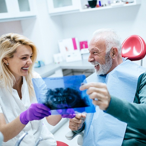 Patient and Jacksonville implant dentist discussing treatment plan