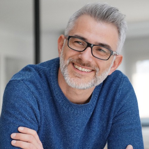 Man with dental implants in Jacksonville, FL sitting and smiling