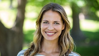 Woman with dental implants in Jacksonville, FL outside smiling