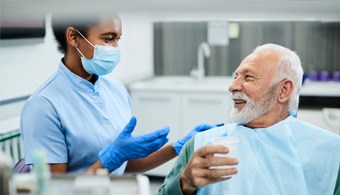 a patient smiling after receiving dentures in Jacksonville