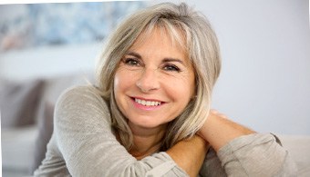 a woman smiling with dentures in Jacksonville