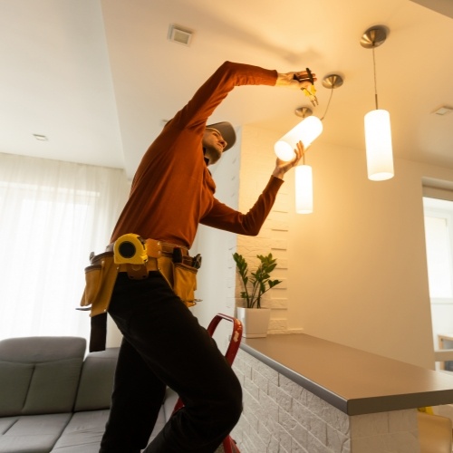 Electrician installing a light in a home