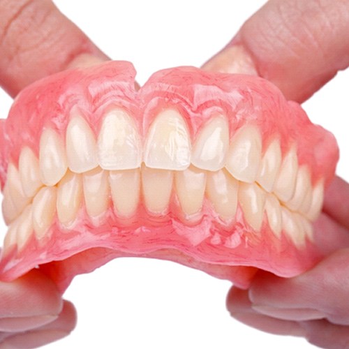 An up-close view of a full set of dentures created for a patient’s smile in Jacksonville