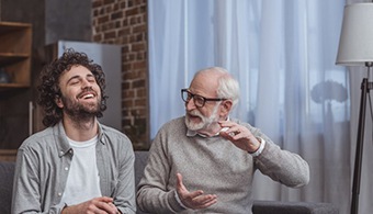 an older man talking with a younger man