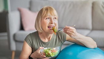 a woman with dentures eating a healthy meal