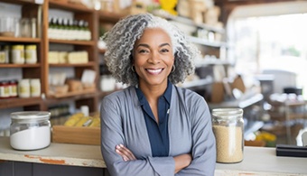 a woman smiling with her arms folded