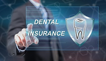 Dentist in Jacksonville pointing to dental insurance graphic