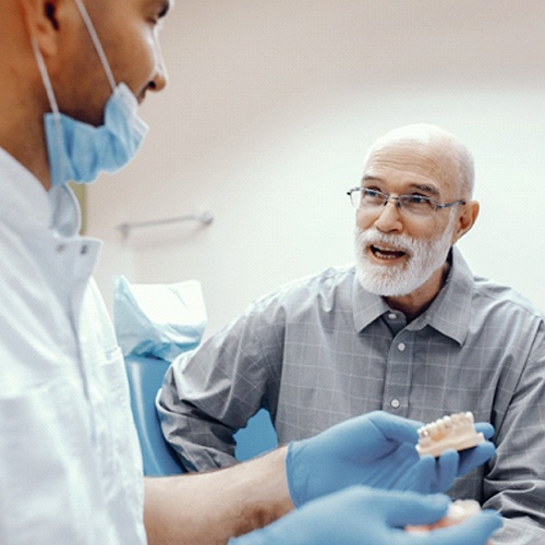 An implant dentist in Jacksonville discussing a male patient’s eligibility for treatment