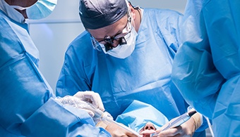 Dentists performing a dental implant surgery