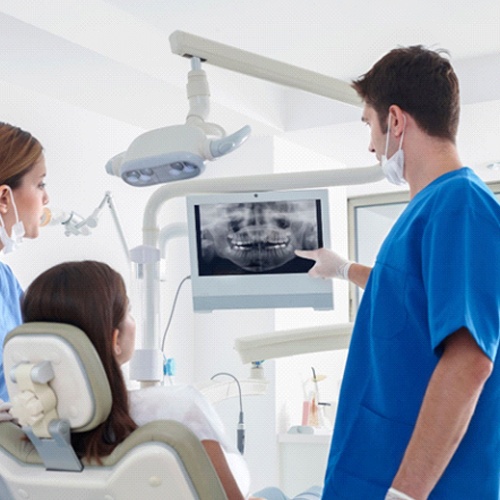 implant dentist in Jacksonville showing a patient their X-rays