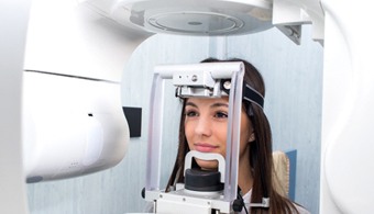 woman getting a 3D cone beam scan of her face and jaw