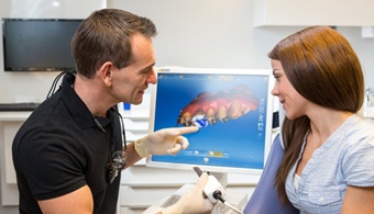 dentist showing a patient a digital impression of their crown