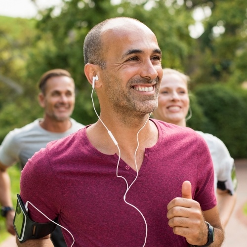 Man running after dental implant tooth replacement