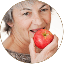 woman biting into apple