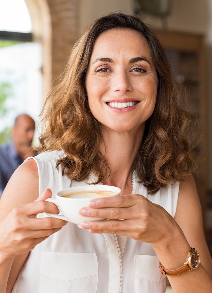 Woman with healthy smile after periodontal therapy