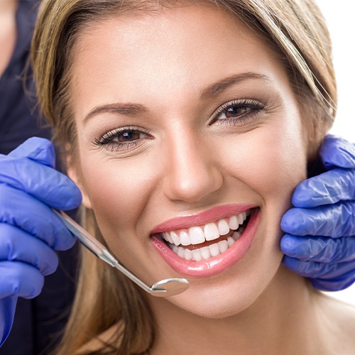Woman smiling during dental checkup and teeth cleaning