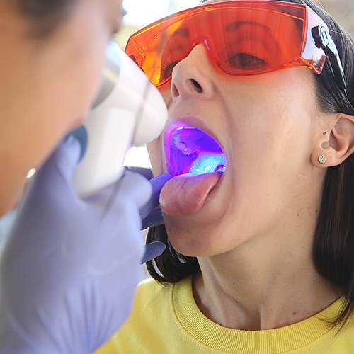 Woman receiving oral cancer screening