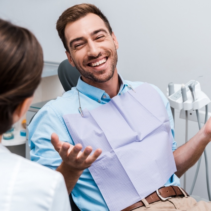 Laughing man receiving dental services