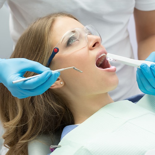 Dentist using intraoral camera to capture smile images