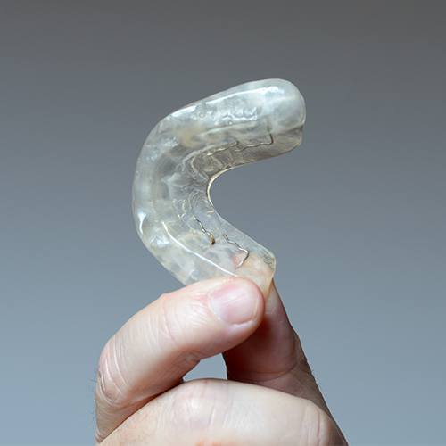 Hand holding an occlusal splint