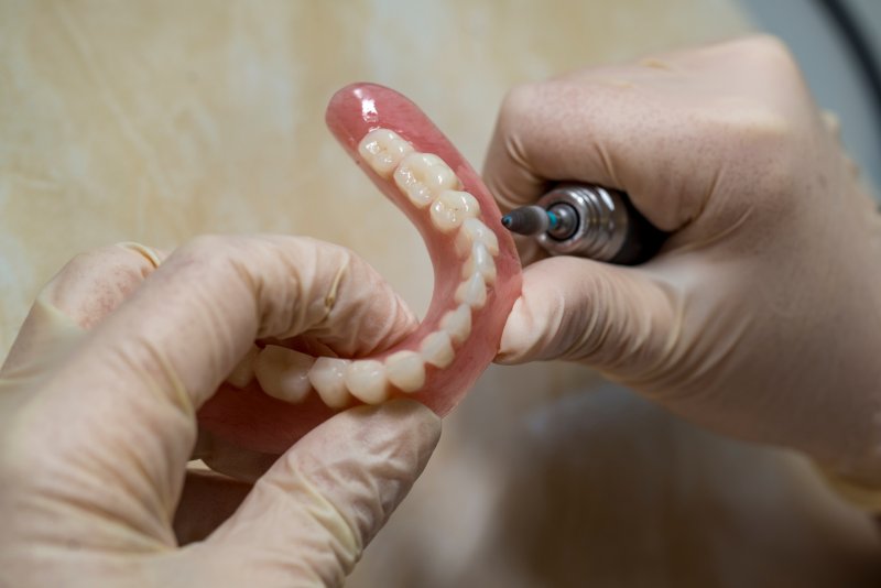 Dentist working on dentures