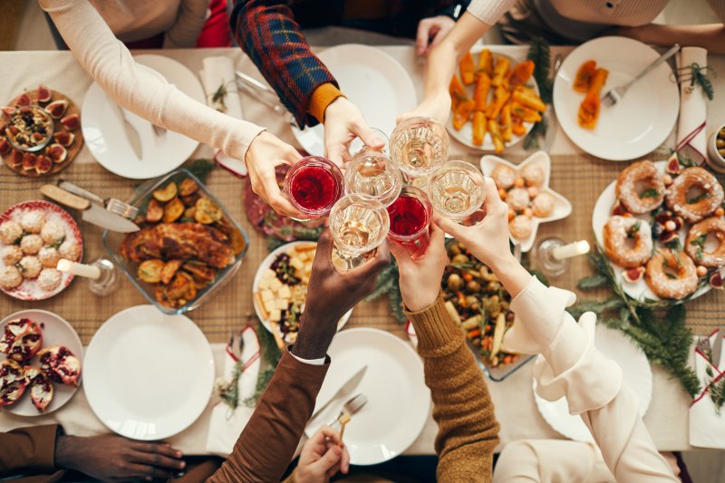 Friends enjoying holiday wine during their feast