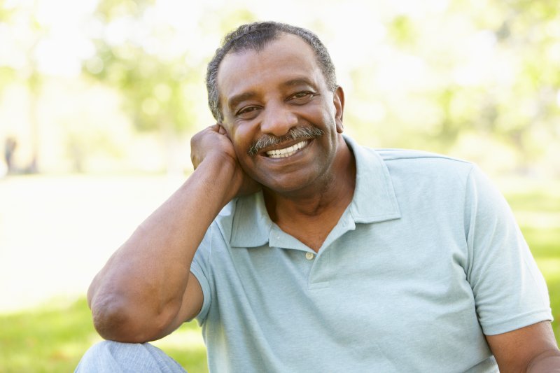 Older man smiling with his lower denture in place