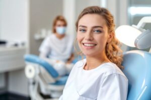 Beautiful, smiling young woman in dental chair