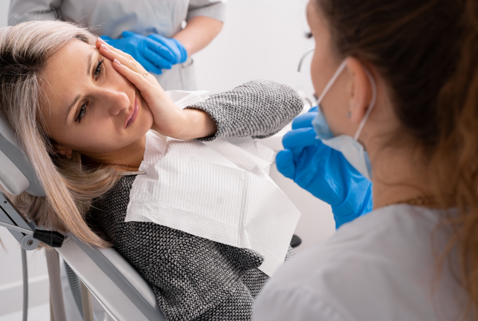 Patient in dental chair looking miserable