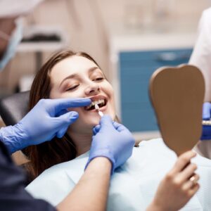 dentist using shade guide in preparation for veneers