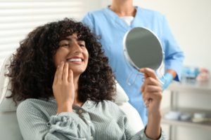 a person examining their smile in a mirror
