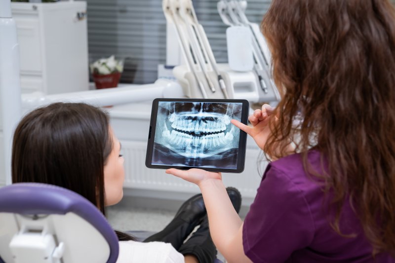 Patient with good oral health learning about their mouth at the dentist